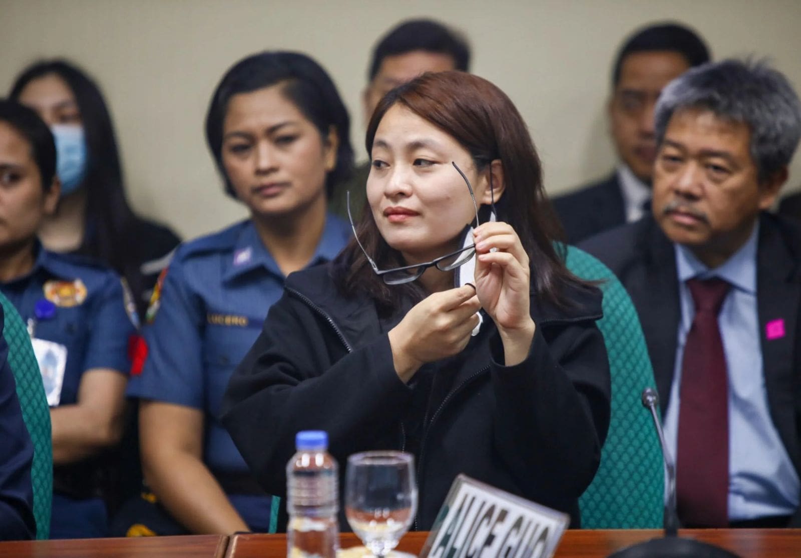 Alice Guo cleaning her glasses during Senate hearing