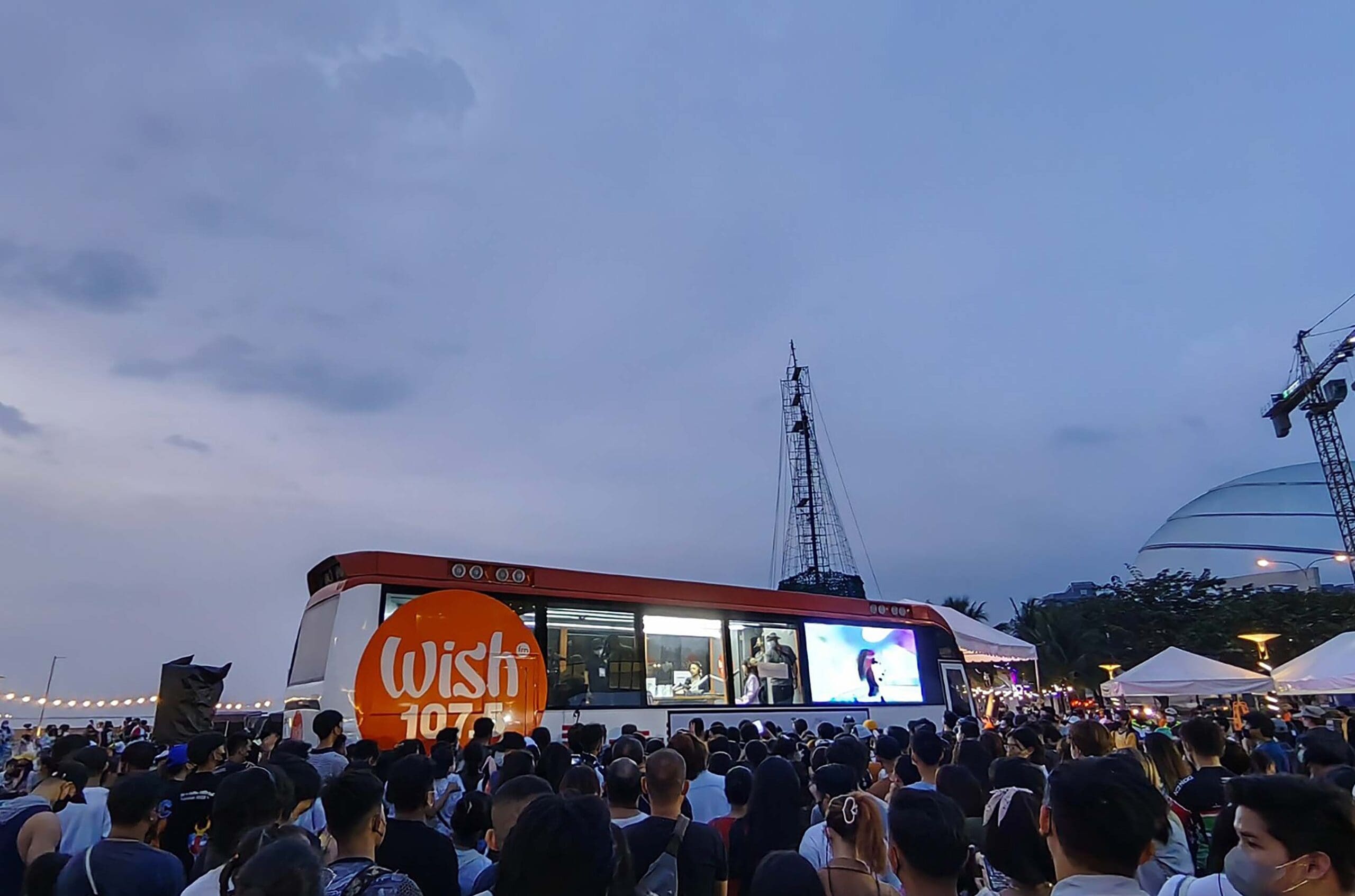 wish 107.5 bus in sm moa with a crowd outside it