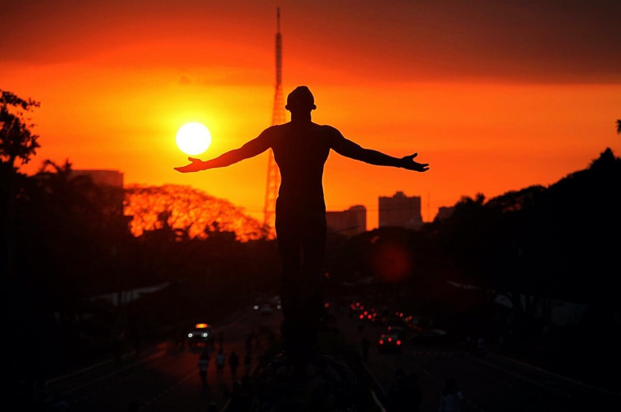 up diliman oblation statue at sunset