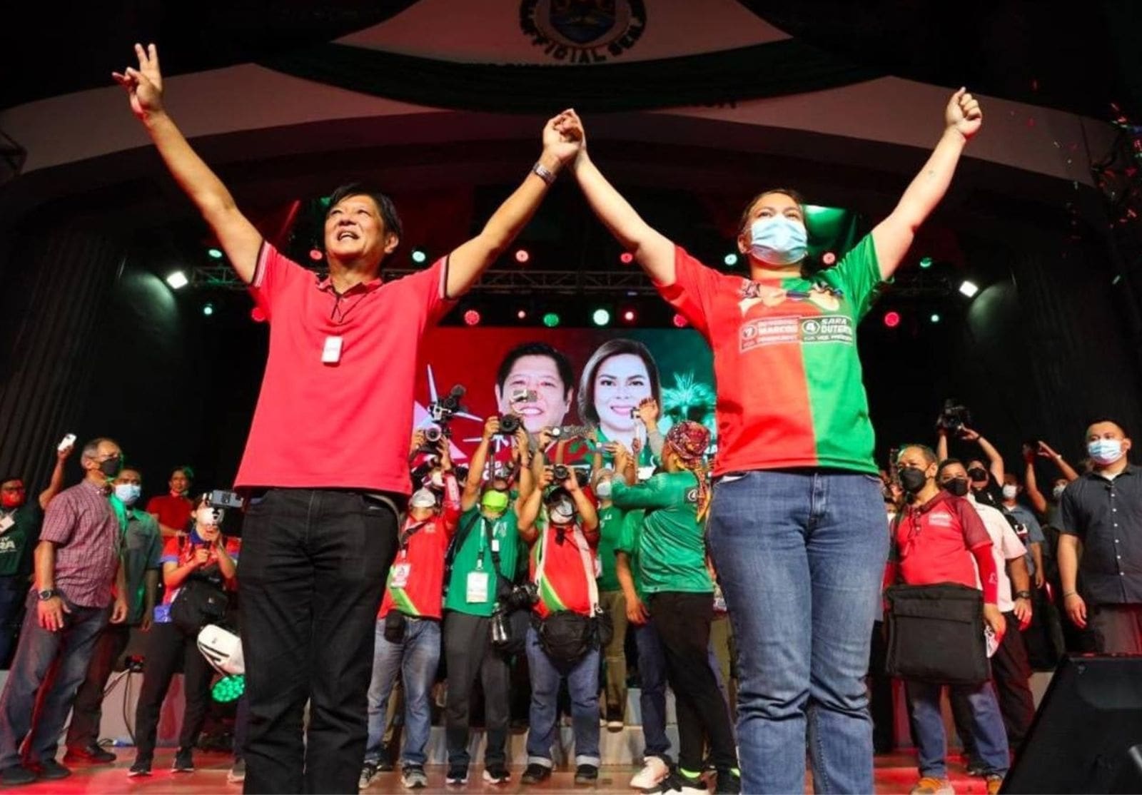 Ferdinand Marcos Jr. and Sara Duterte stand hand-in-hand onstage at an election campaign