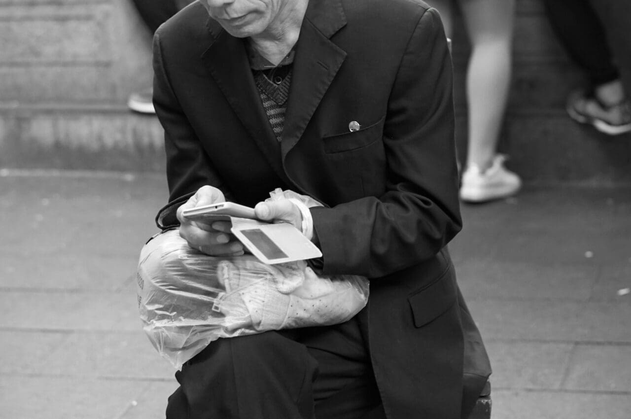 man in a suit holding a smartphone