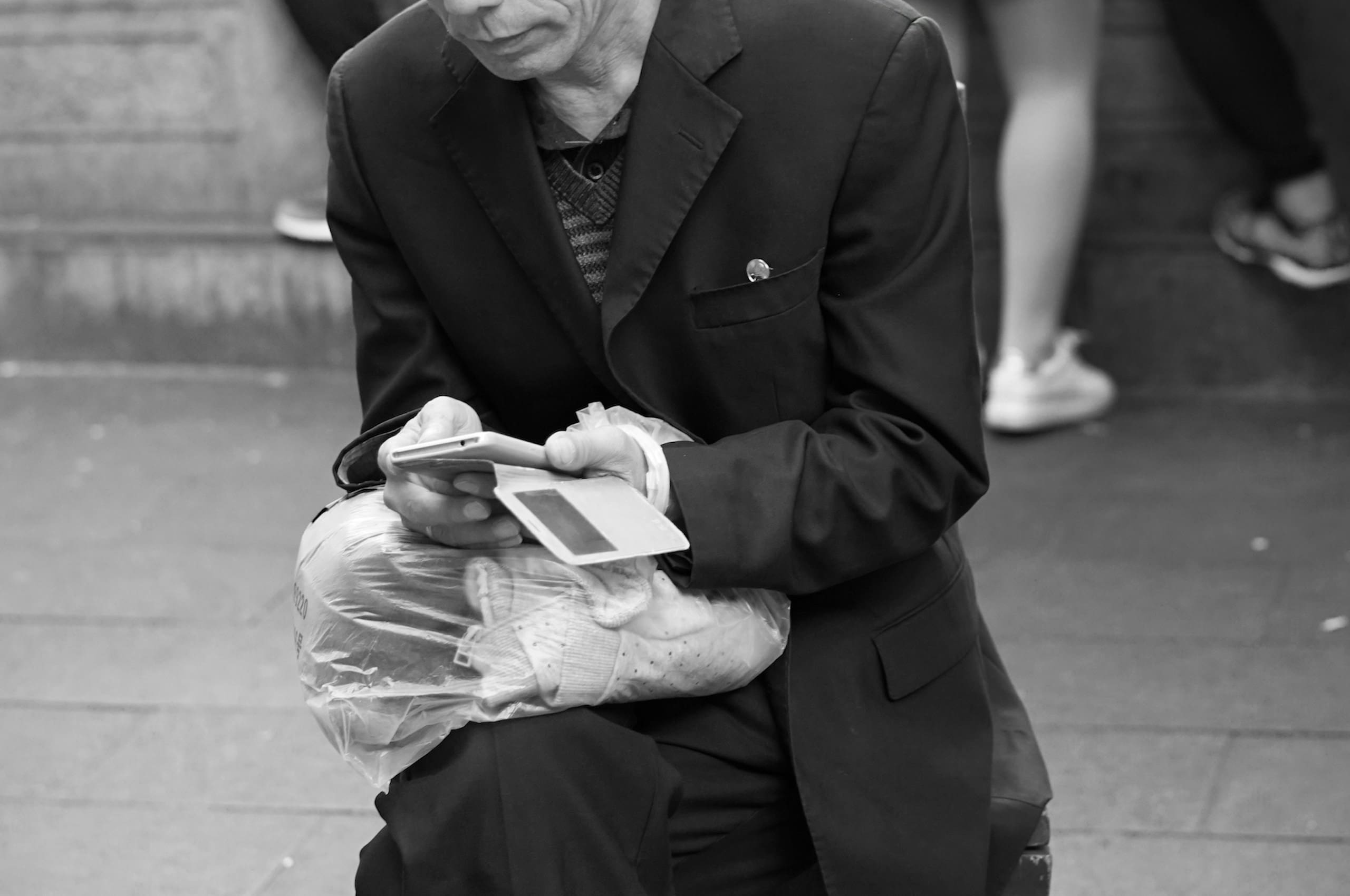 man in a suit holding a smartphone